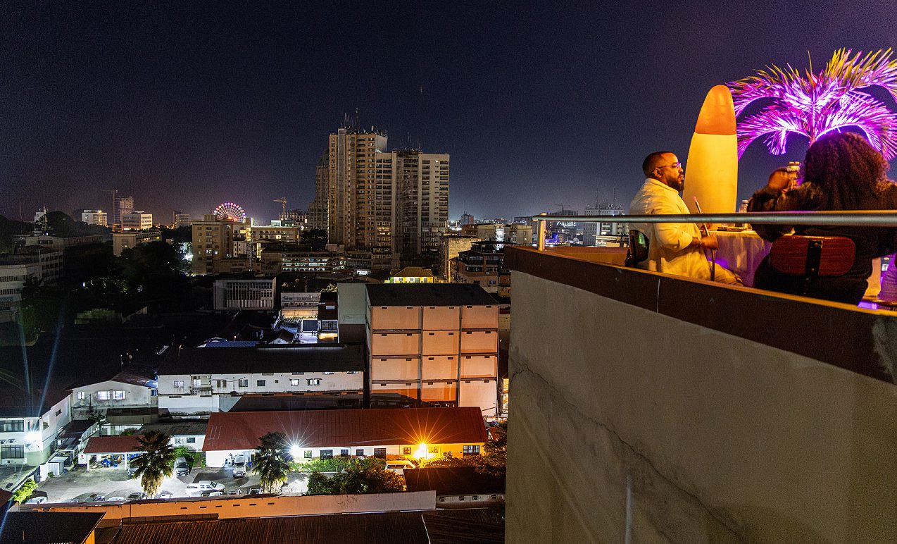 An upmarket neighbourhood Kinshasa at night, bustling against a backdrop of music and business. PASCAL MAITRE