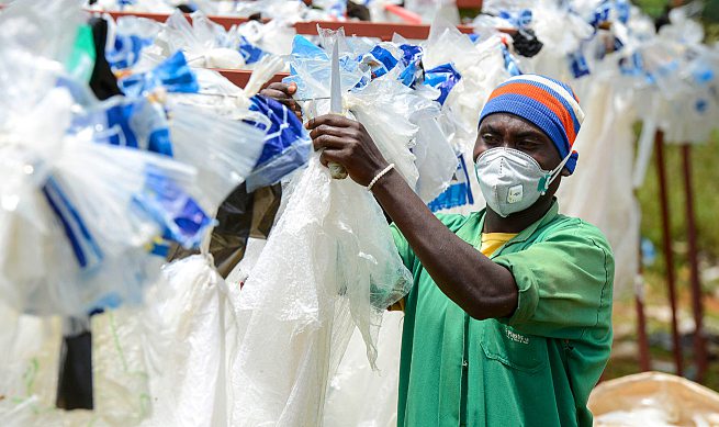 An employee at the Rwandan recycling company EcoPlastic. ALAMY