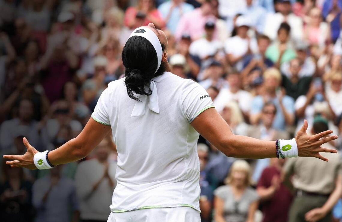 On 12 July 2023, at Wimbledon, Ons Jabeur celebrates her quarter-final victory against Elena Rybakina. ADAM STOLTMAN/ALAMY