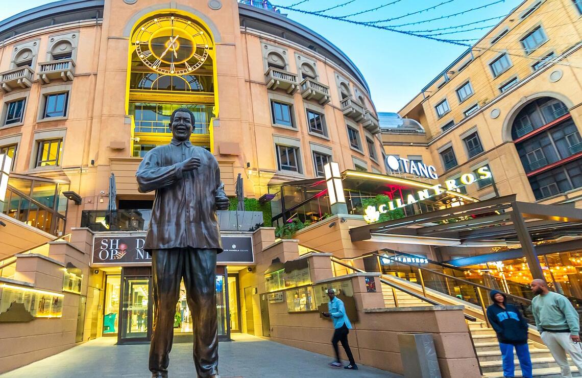 Johannesburg, South Africa: Divisions and wealth Statue of former South African President Nelson Mandela in Nelson Mandela Square shopping centre, Sandton. SHUTTERSTOCK